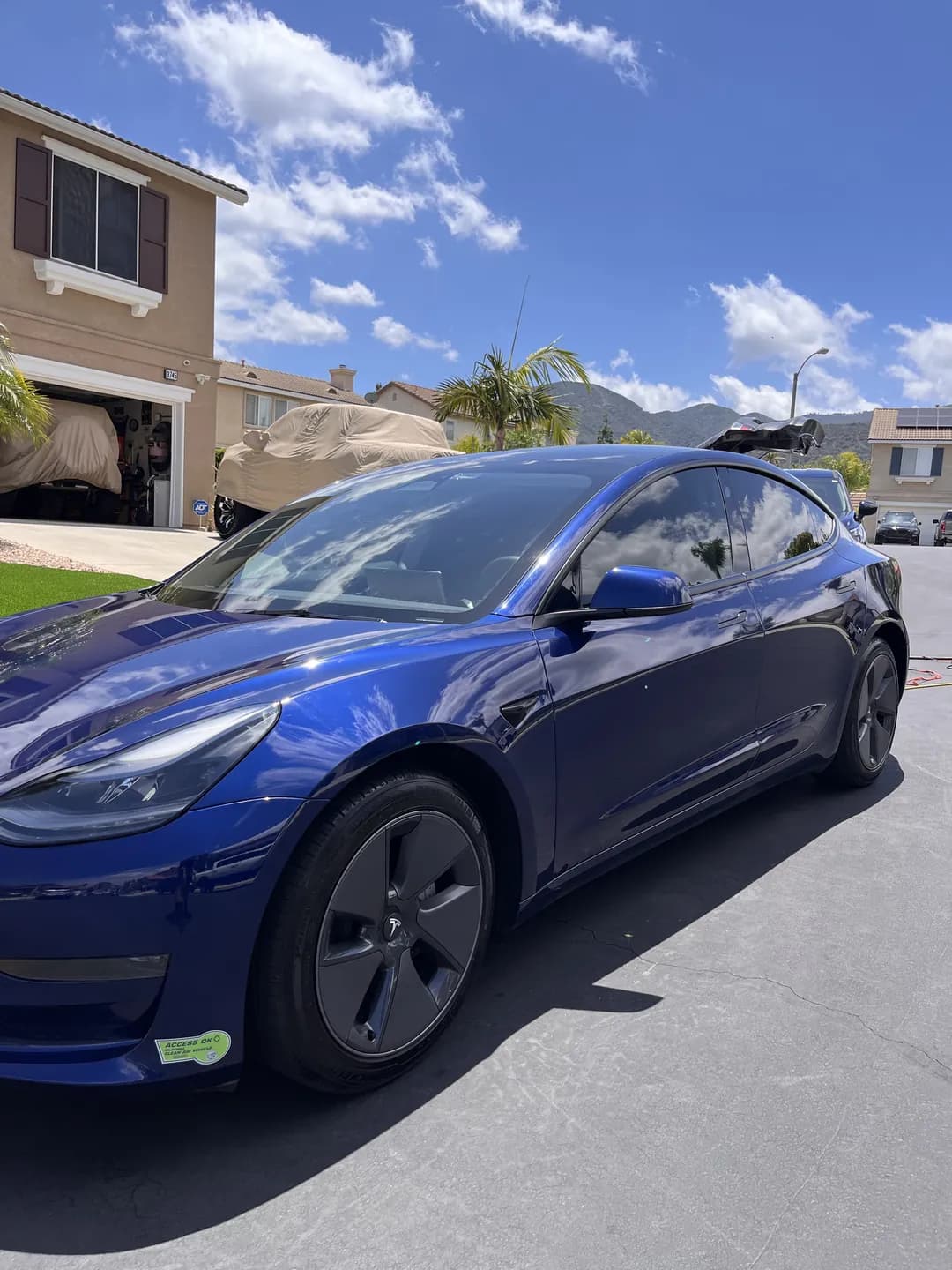 Blue Tesla viewed from the front corner