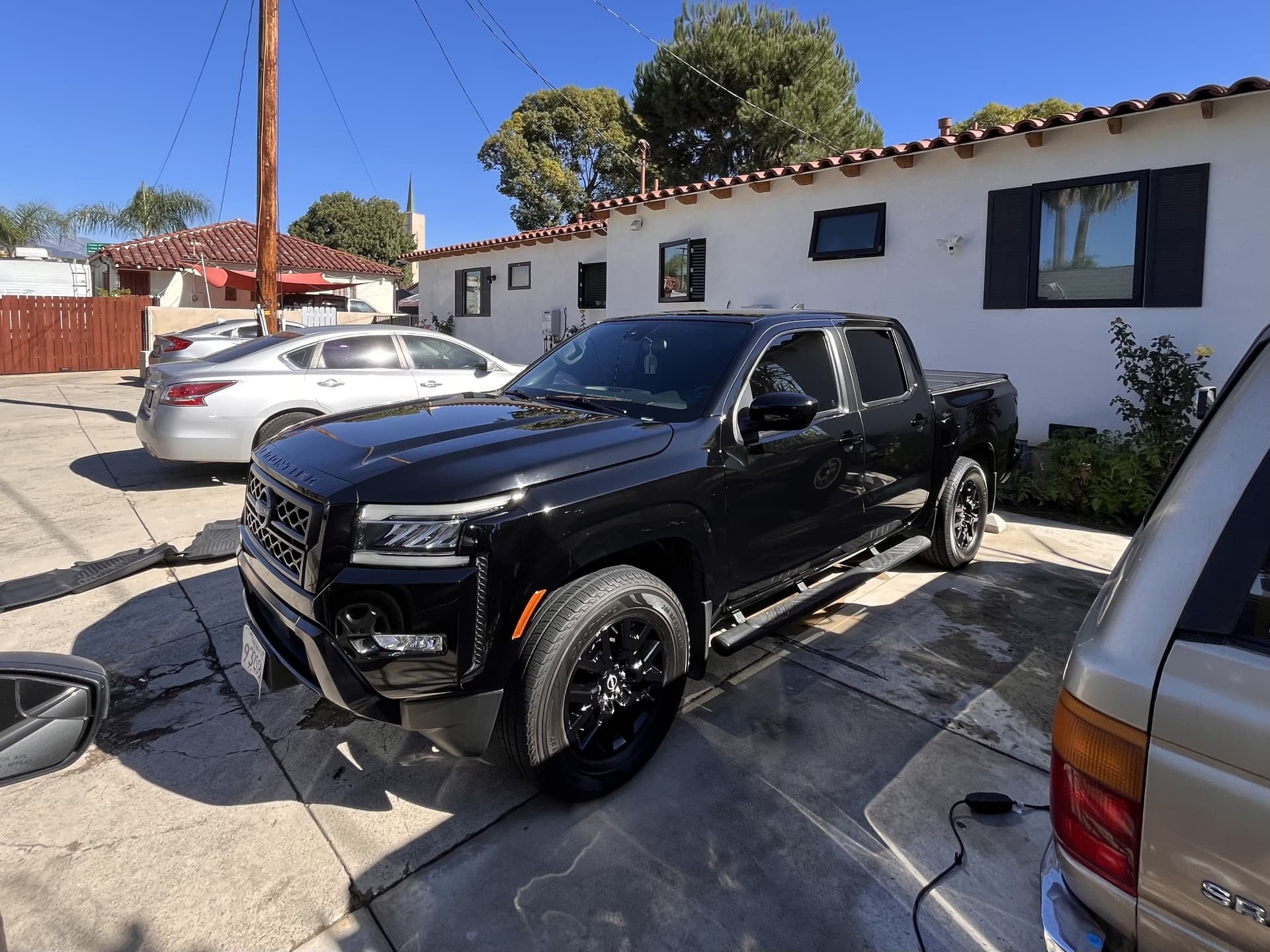 Black Nissan pickup truck with freshly detailed glossy paint