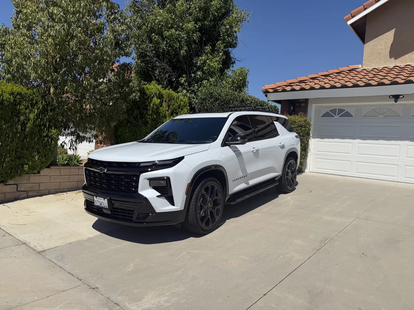 White crossover with black wheels in a driveway